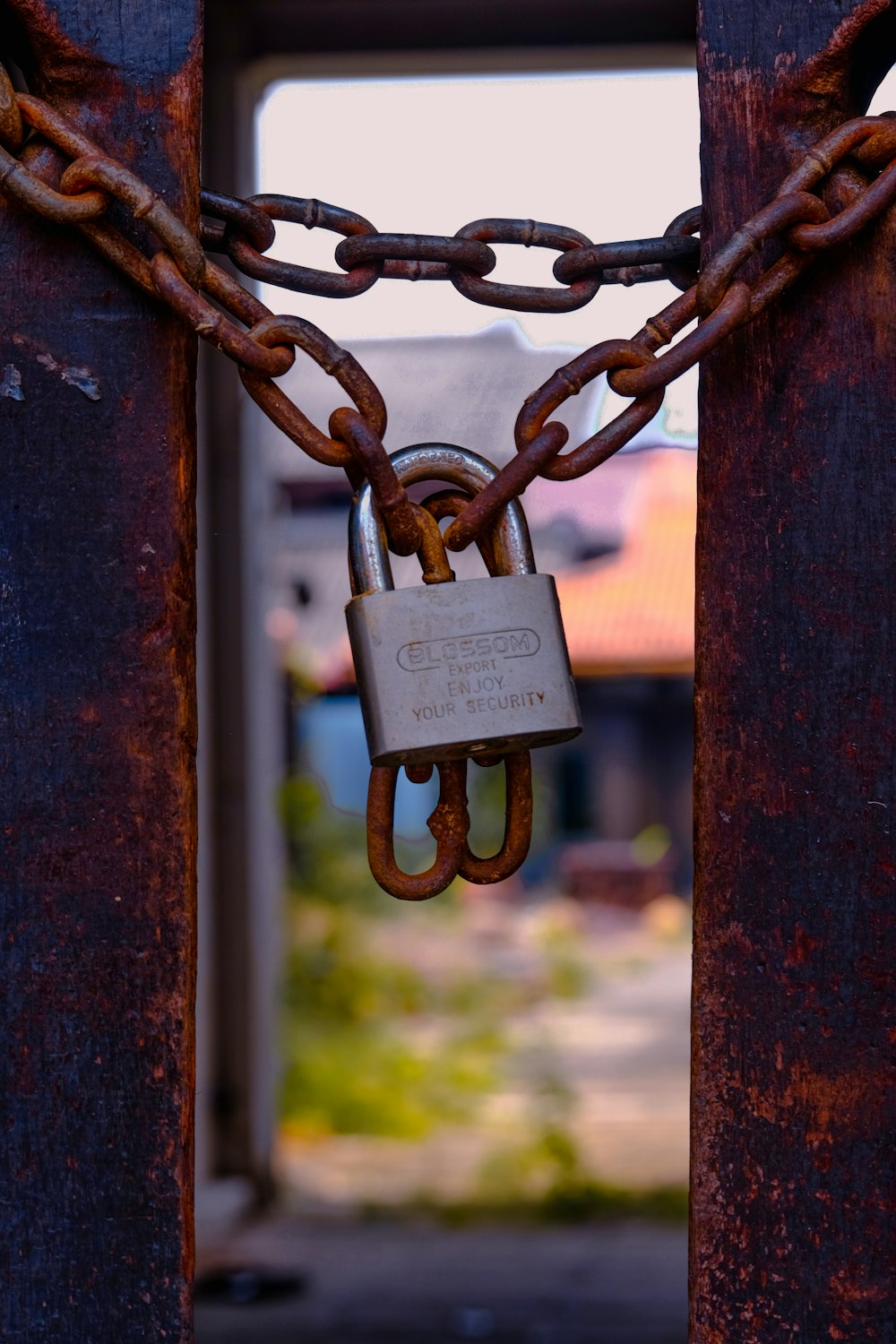 a padlock attached to a gate with a chain