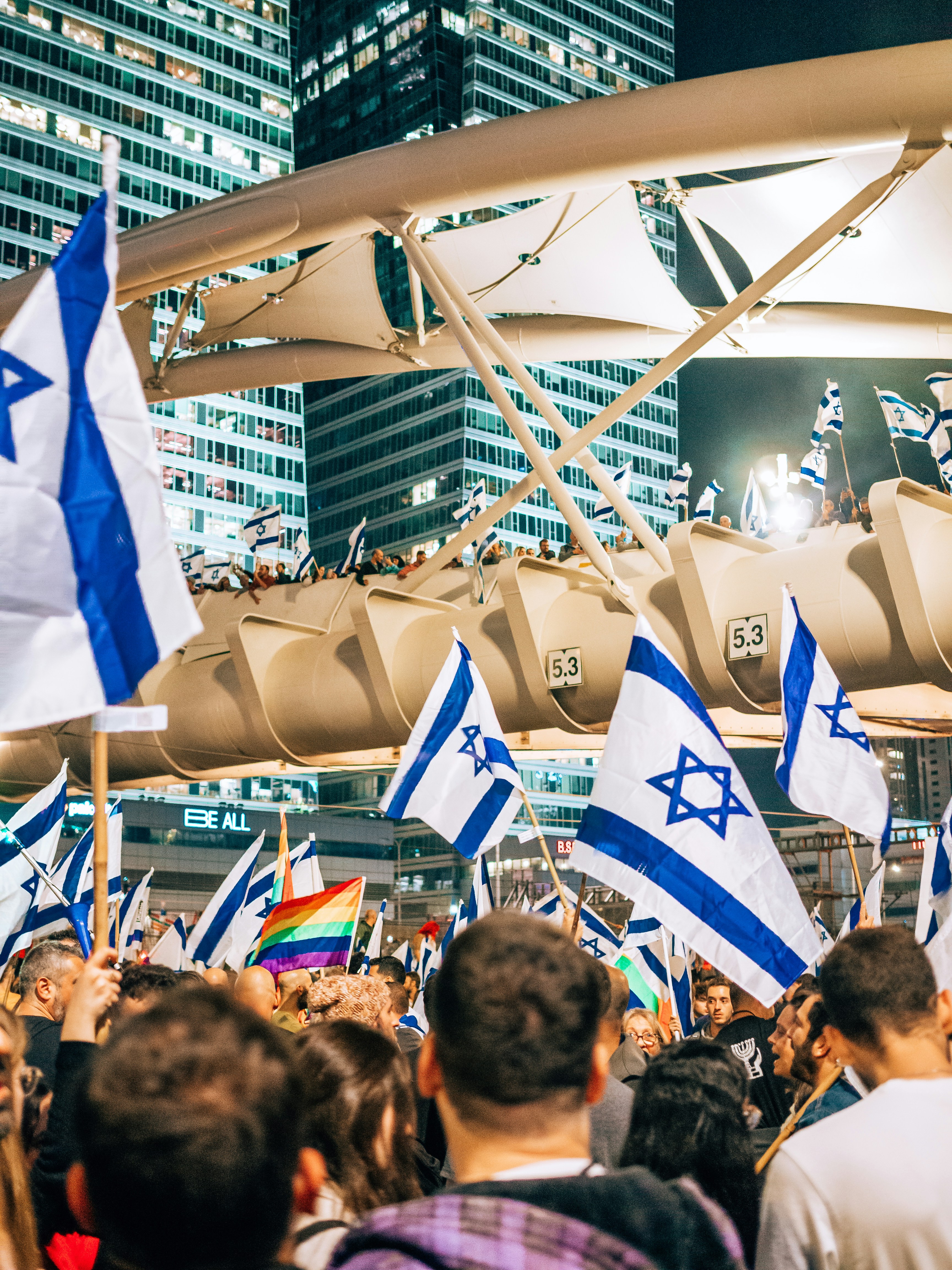 a large group of people holding israeli and israeli flags