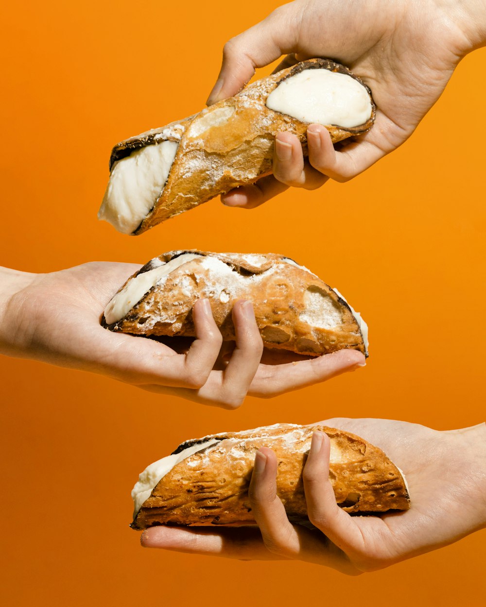 a person holding a piece of bread in their hands