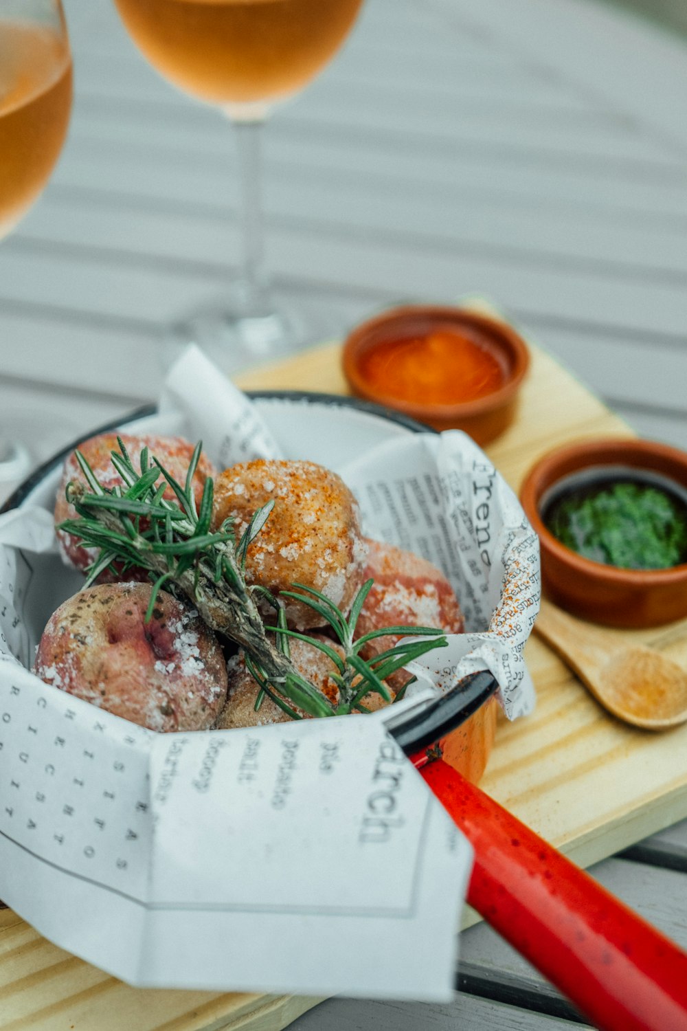 a bowl of food and two glasses of wine