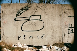 a cement sign with a picture of a vase and a wheat stalk on it