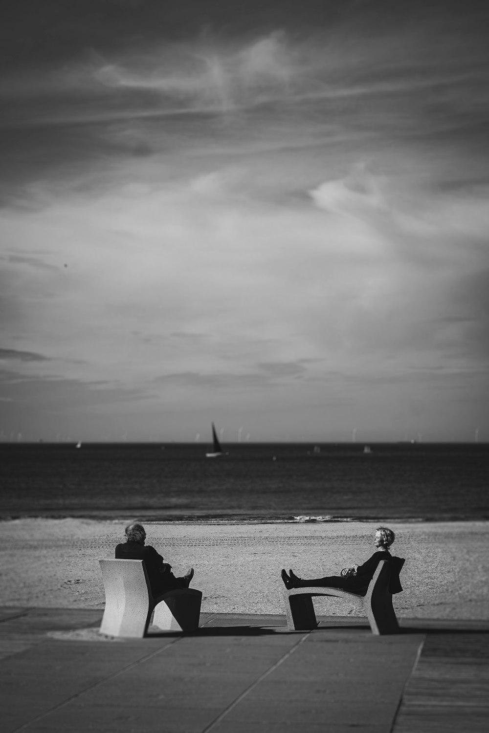 a couple of people sitting on top of a bench