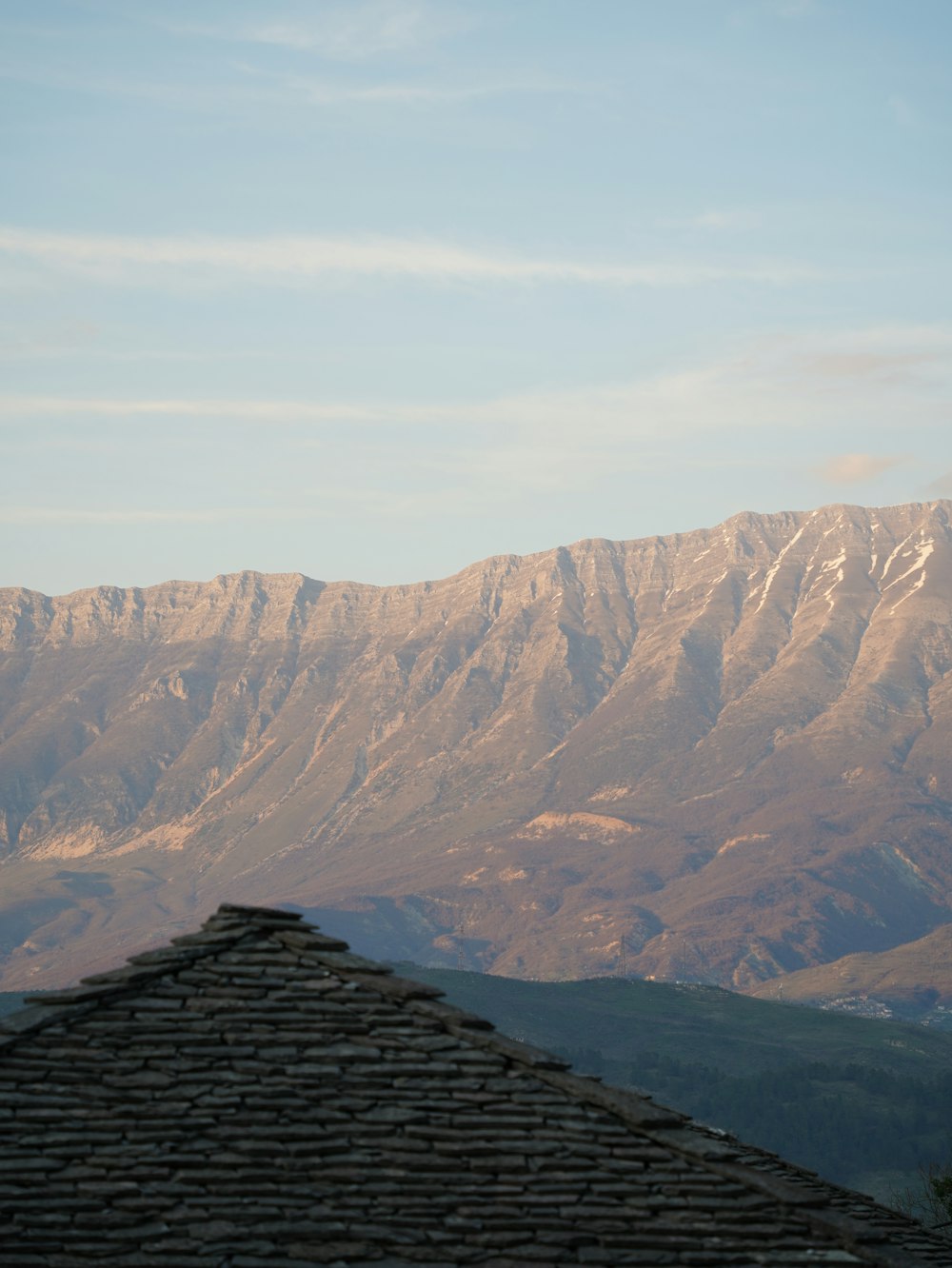a view of a mountain range from a roof
