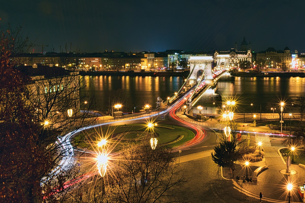 Budapest October — Széchenyi Chain Bridge illuminated at night over the dark Danube in autumn