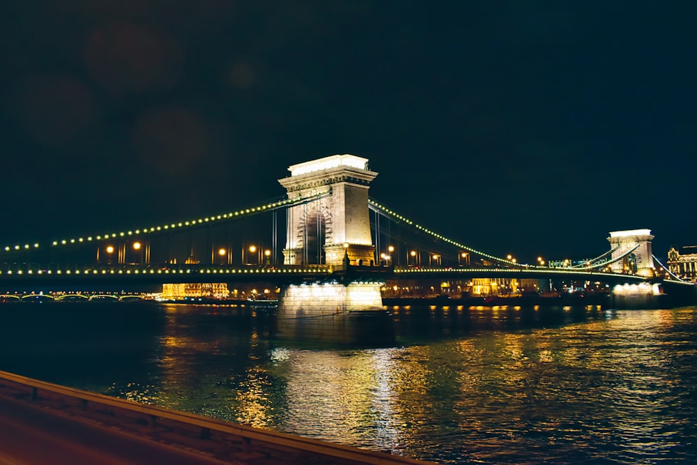 a night view of a bridge over a body of water