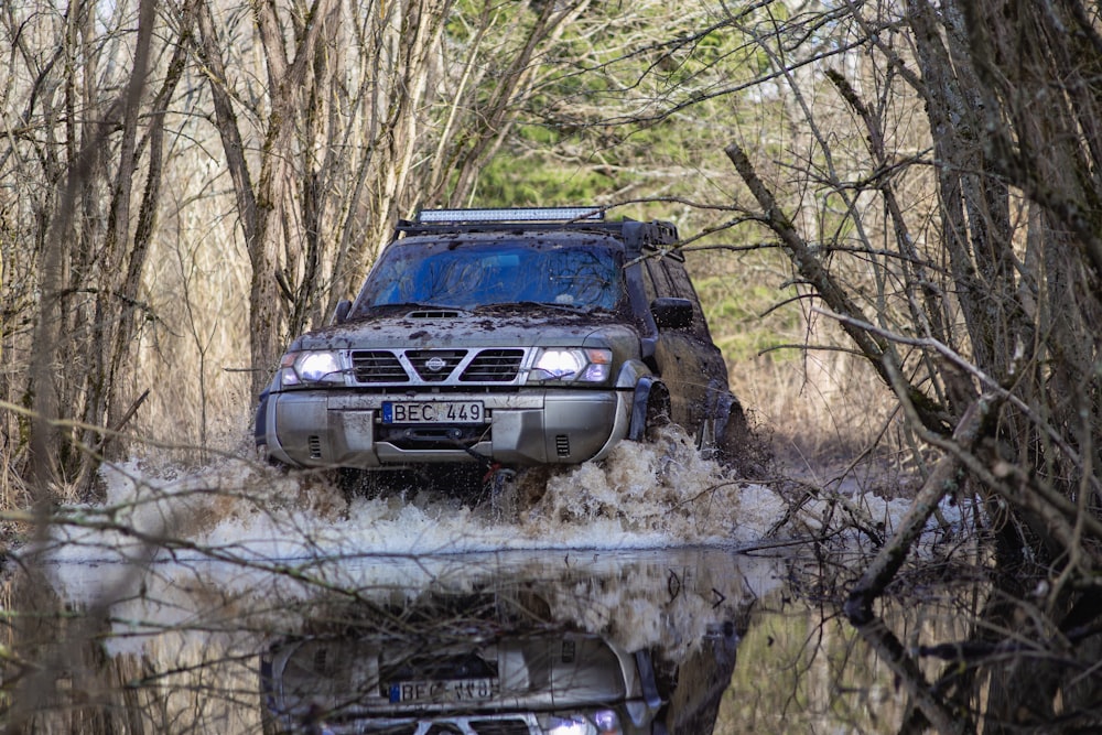 a truck driving through a puddle of water