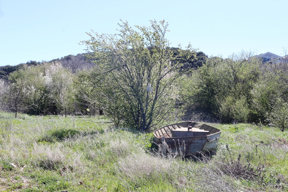 a boat sitting in the middle of a field