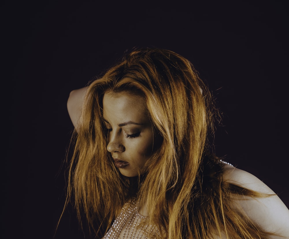 a woman with long hair is posing for a picture