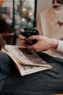 a person sitting on a chair holding a camera