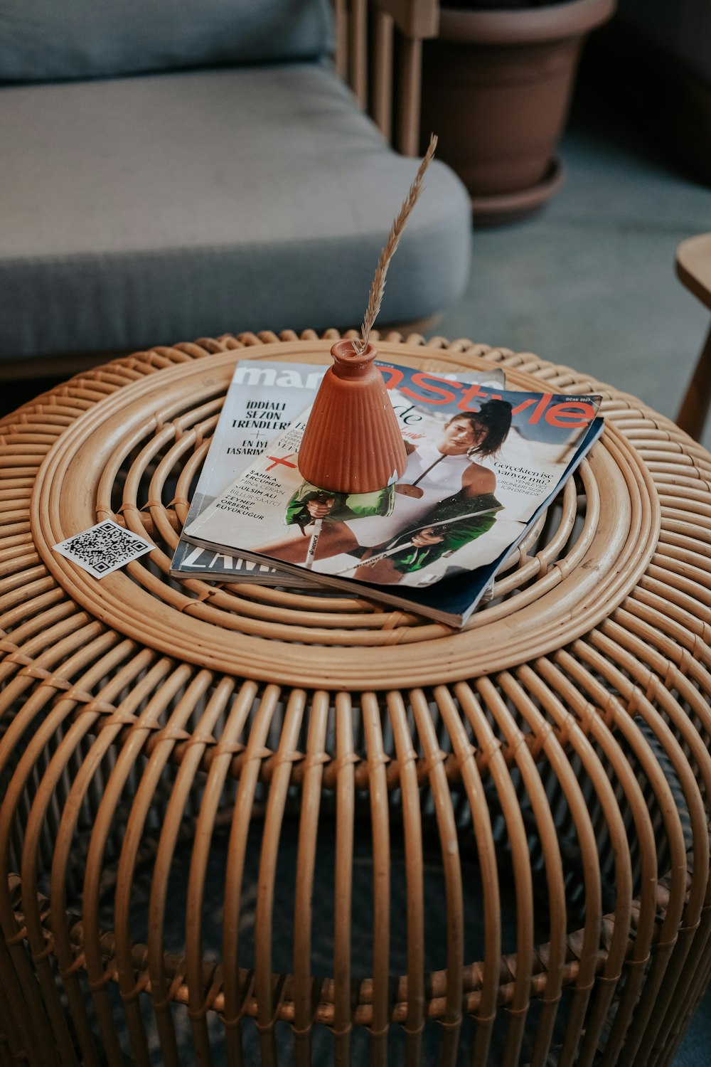 a wicker table with a magazine on top of it