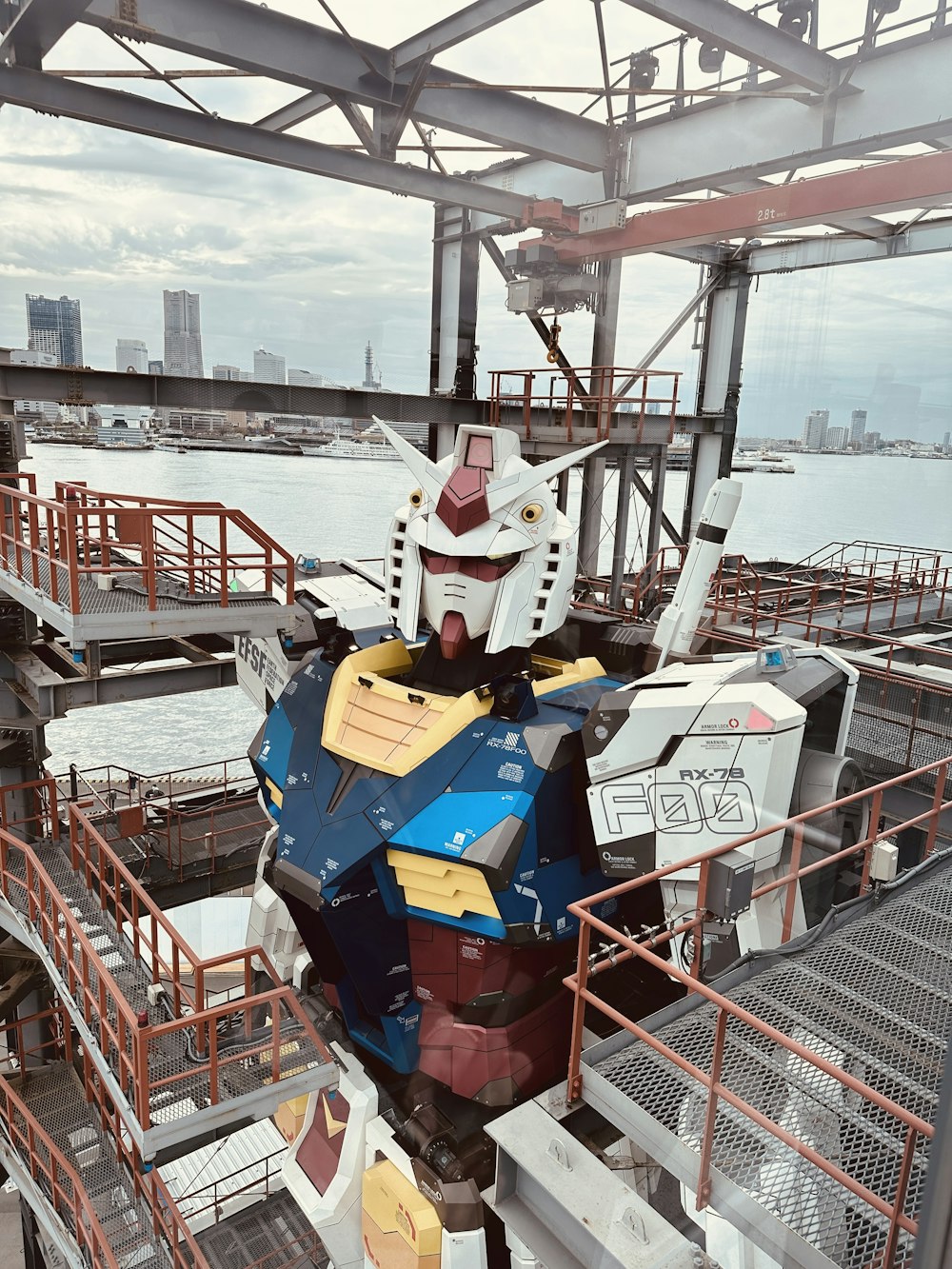 a giant robot statue sitting on top of a boat
