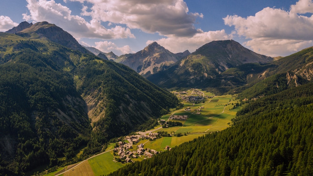 a scenic view of a valley surrounded by mountains