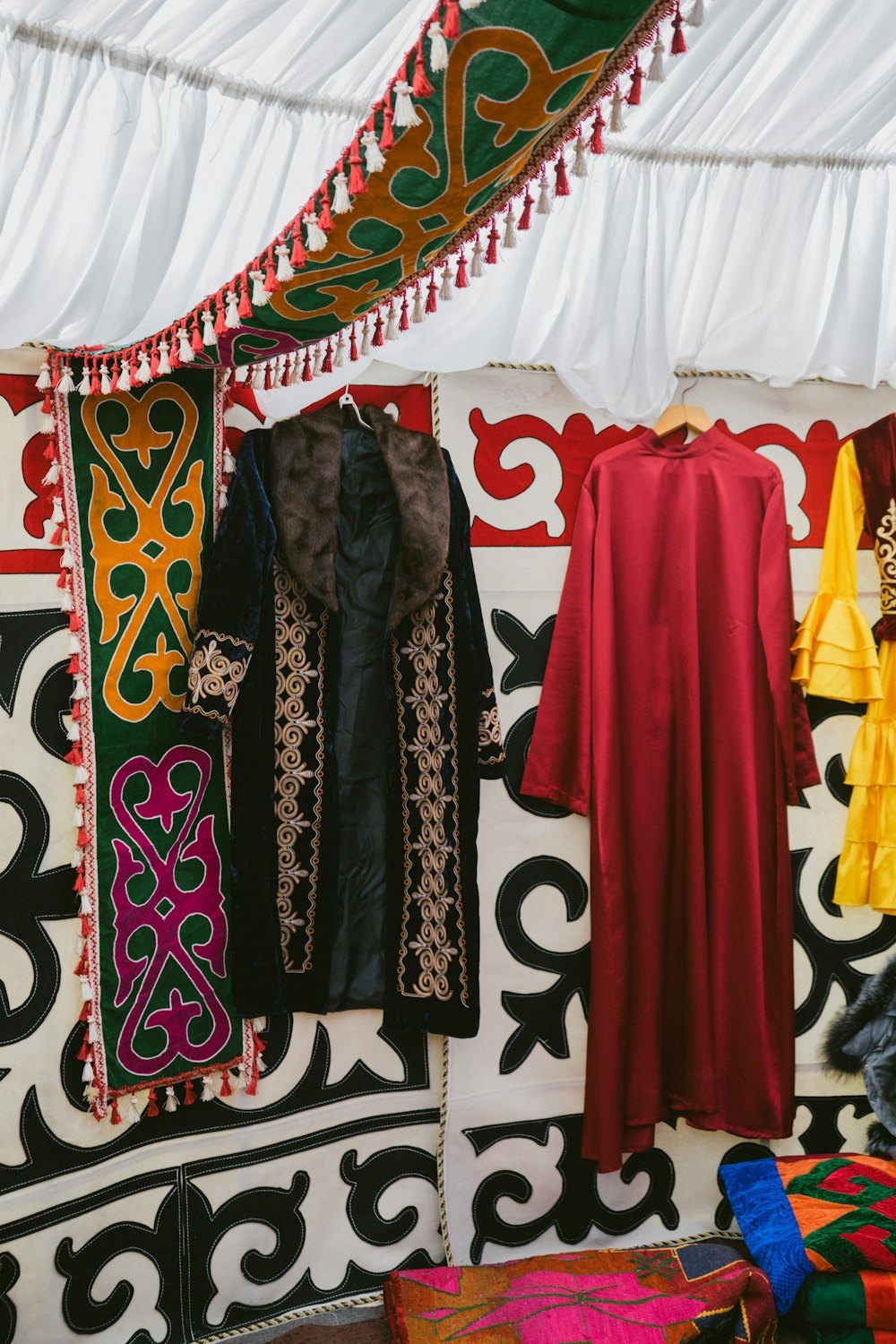 a colorful display of clothing hanging on a wall