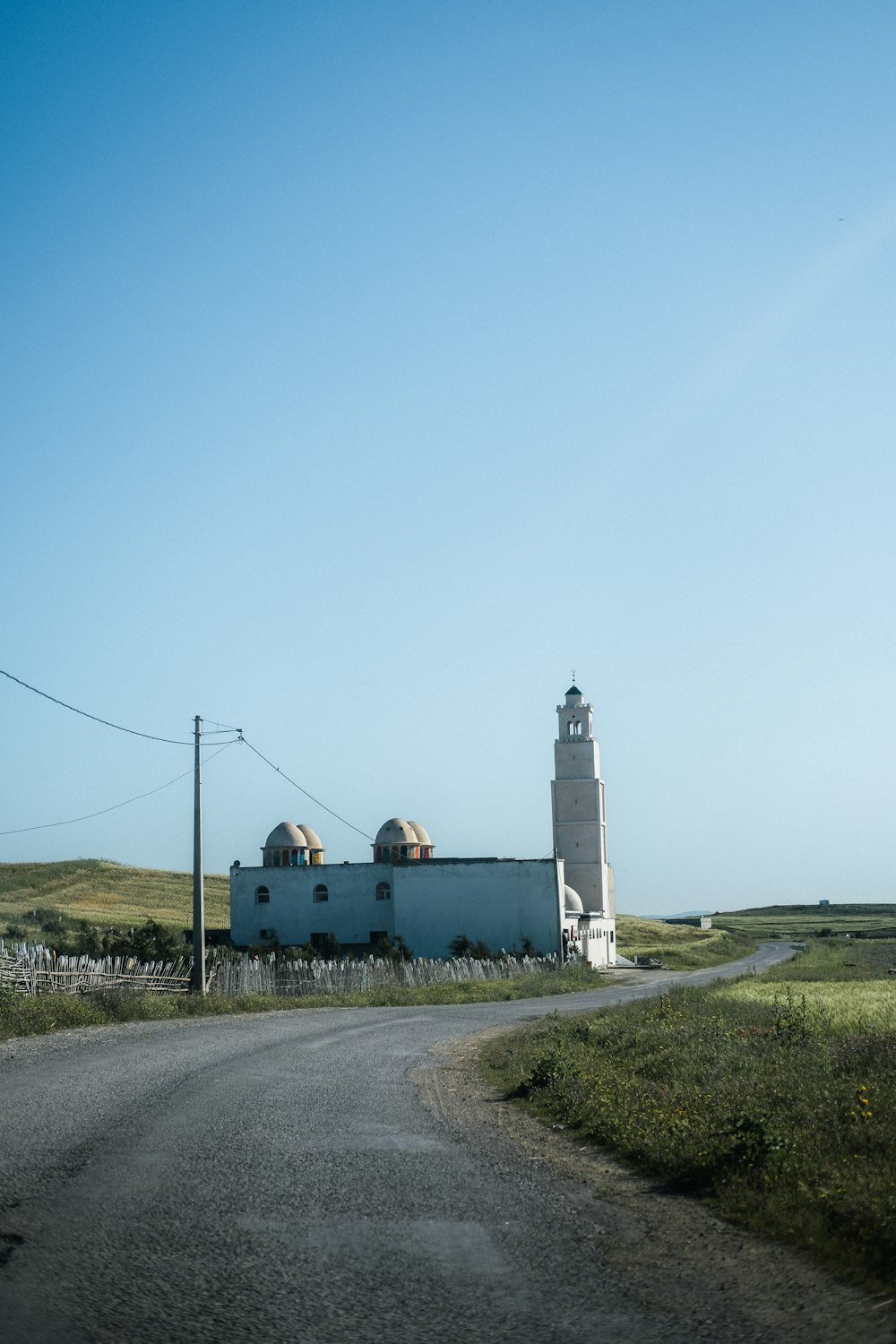 a large white building sitting on the side of a road