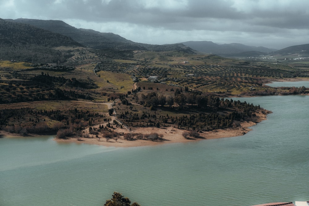 a body of water surrounded by mountains and trees