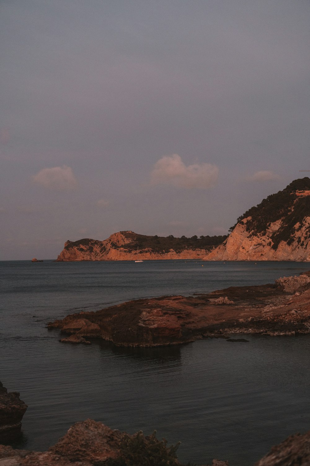 a body of water with a small island in the background