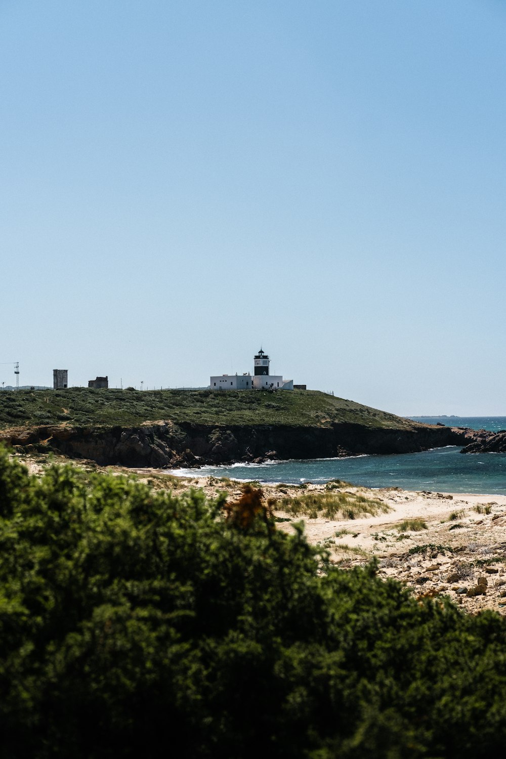 a lighthouse on a small island in the middle of the ocean