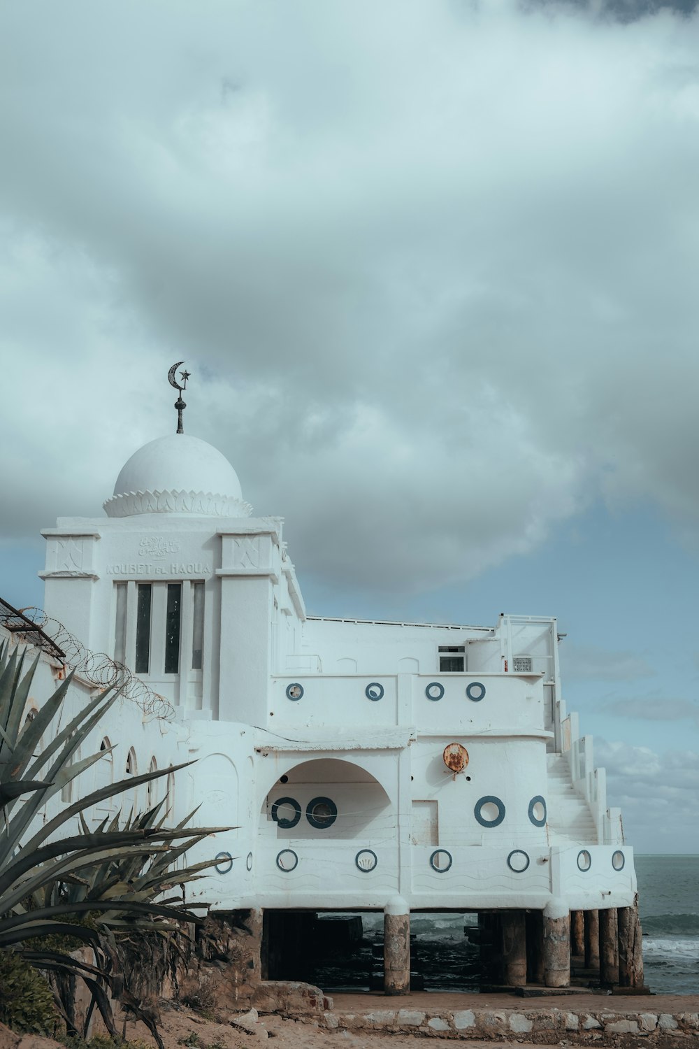 a large white building sitting on top of a beach