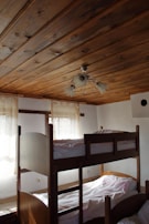 a room with bunk beds and a ceiling fan
