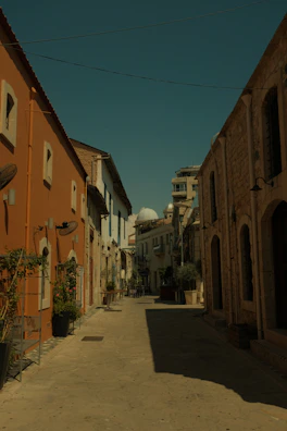 Charming narrow street in Seville lined with orange trees and whitewashed buildings