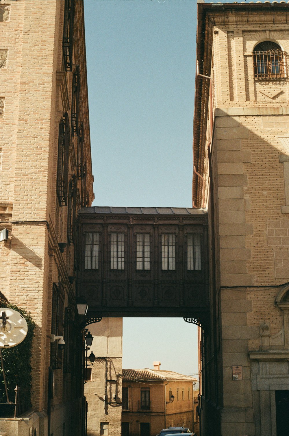 a car driving under a bridge over a street