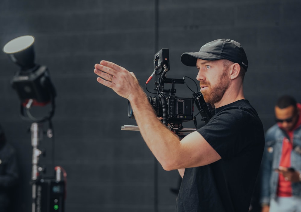 a man holding a camera in front of a camera