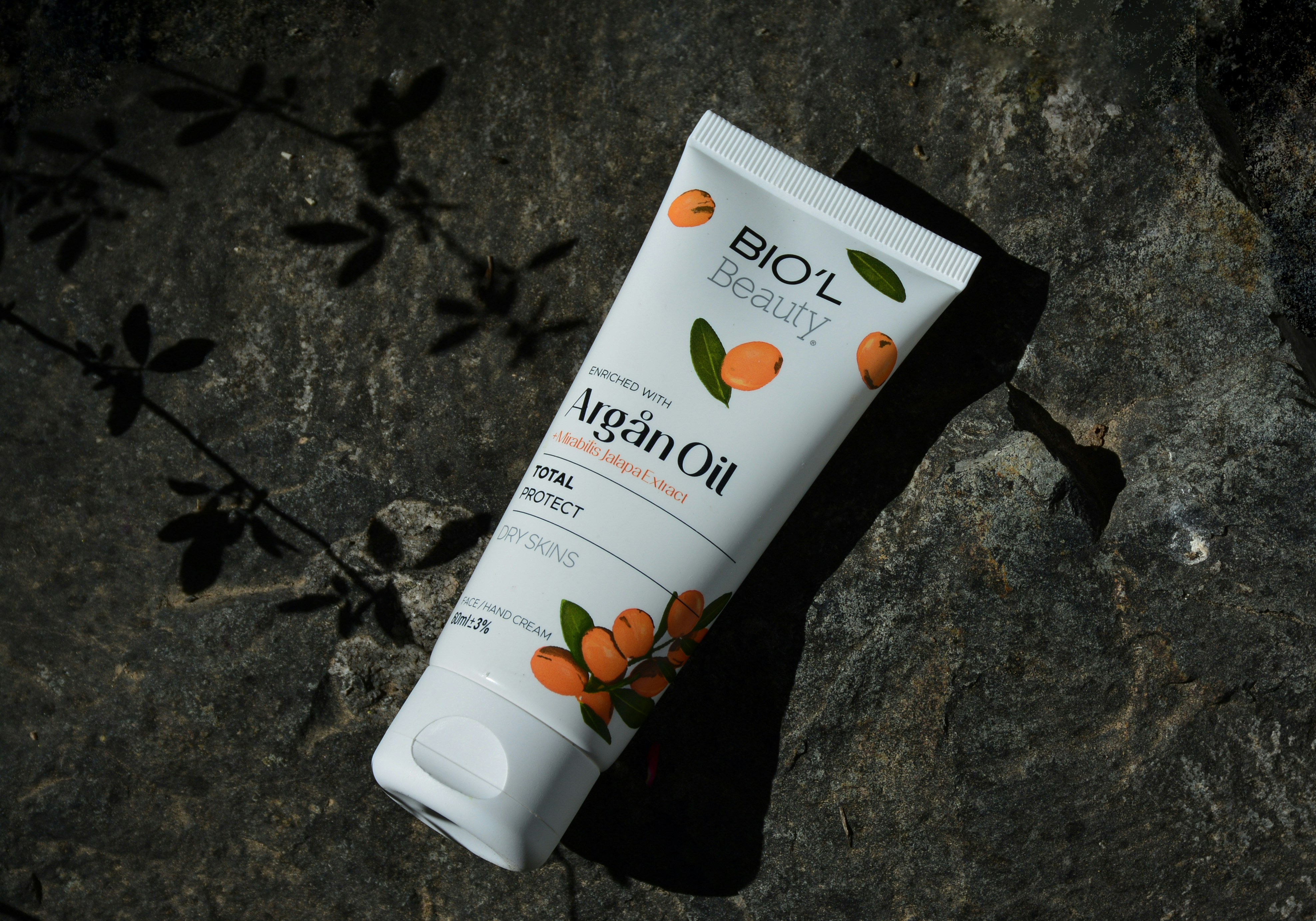 a tube of lotion sitting on top of a rock