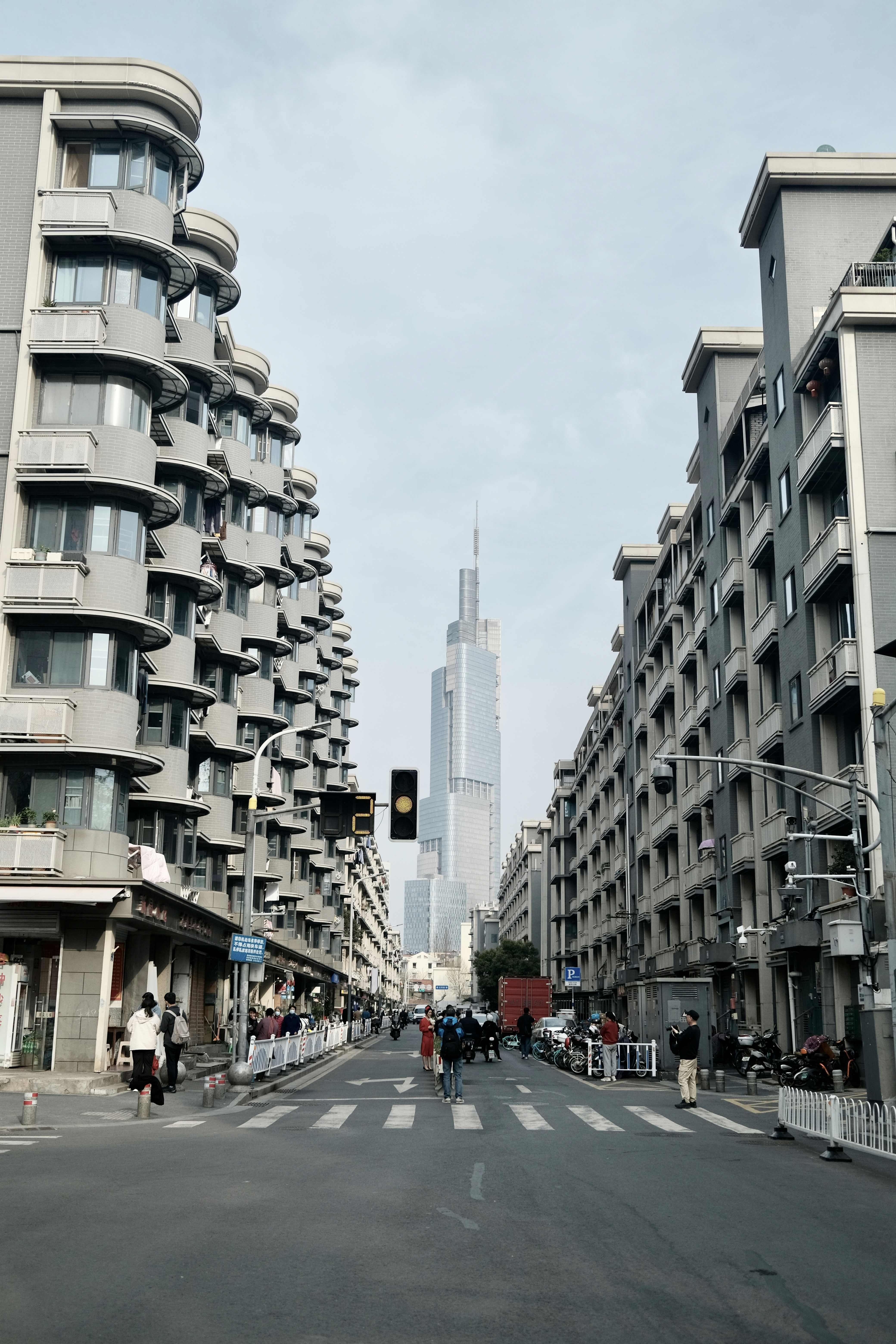 A city street with tall buildings and a traffic light photo – Free ...