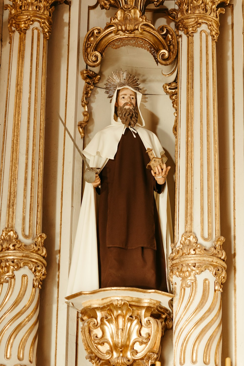 a statue of a man with a beard in a church