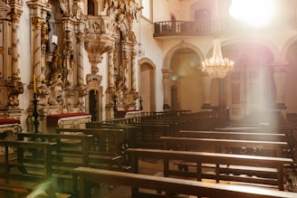 A warm, sunlit chapel interior ready for a wedding ceremony.