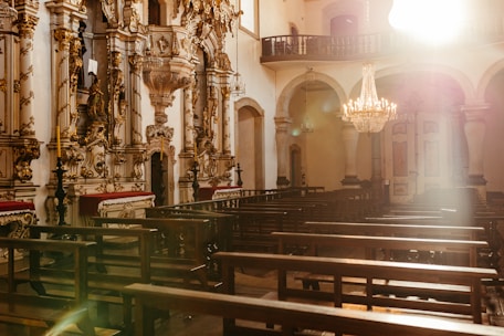 A warm, sunlit chapel interior ready for a wedding ceremony.