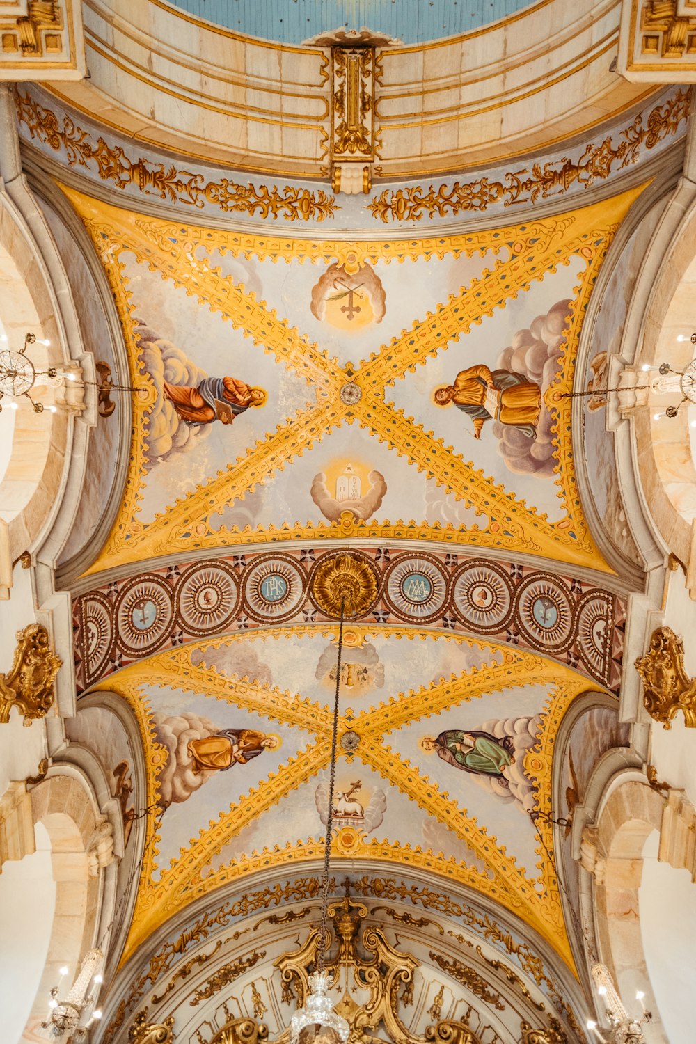 the ceiling of a church with a clock on it