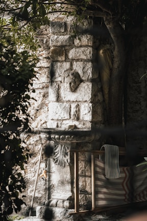 a stone fireplace with a chair next to it