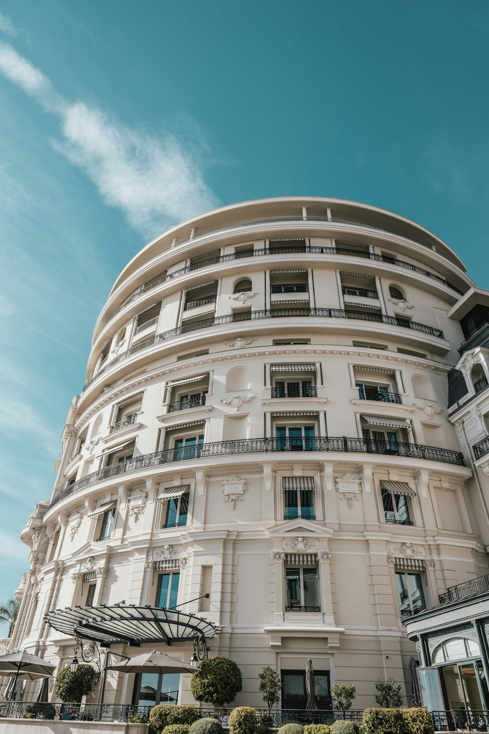 a large white building with balconies on the top of it