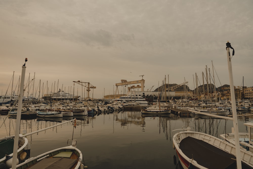 a harbor filled with lots of boats under a cloudy sky