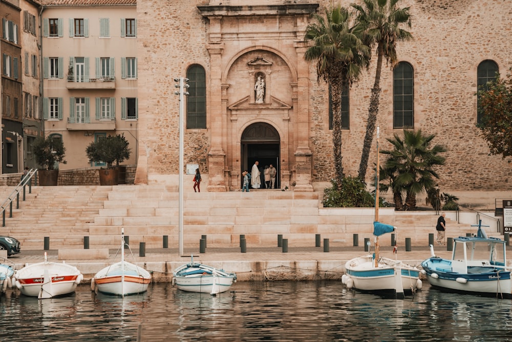 a group of small boats sitting in front of a building