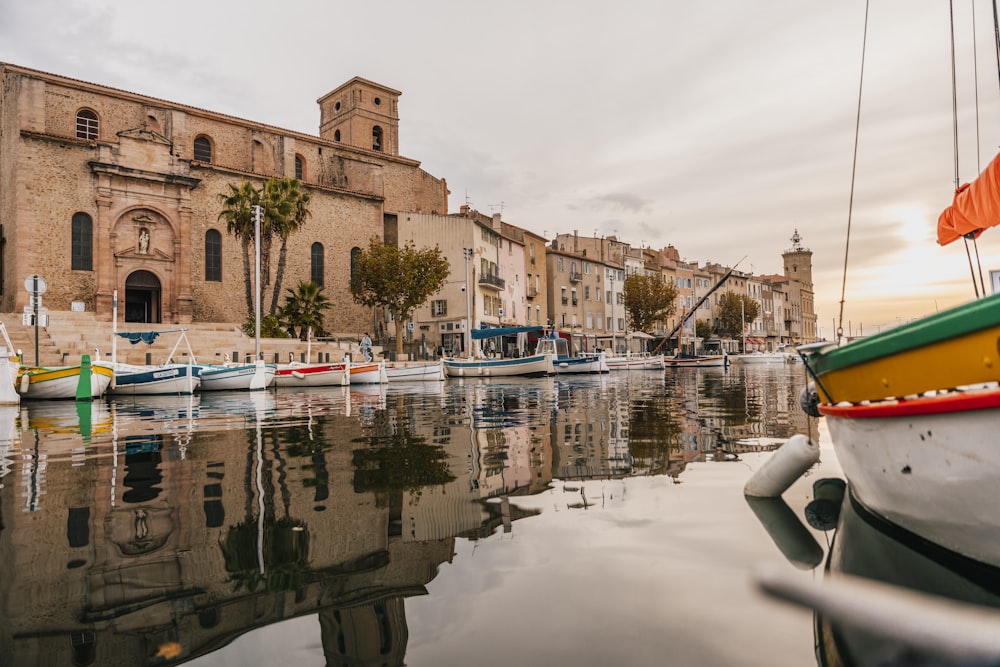 boats are docked in the water in front of a building