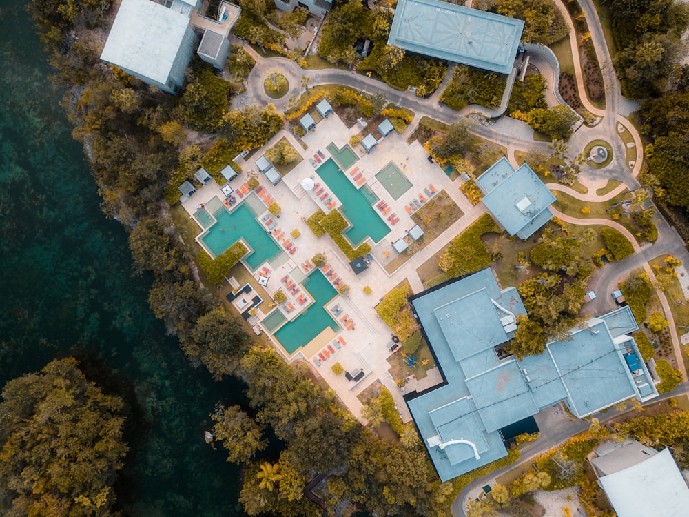 an aerial view of a blue building surrounded by trees