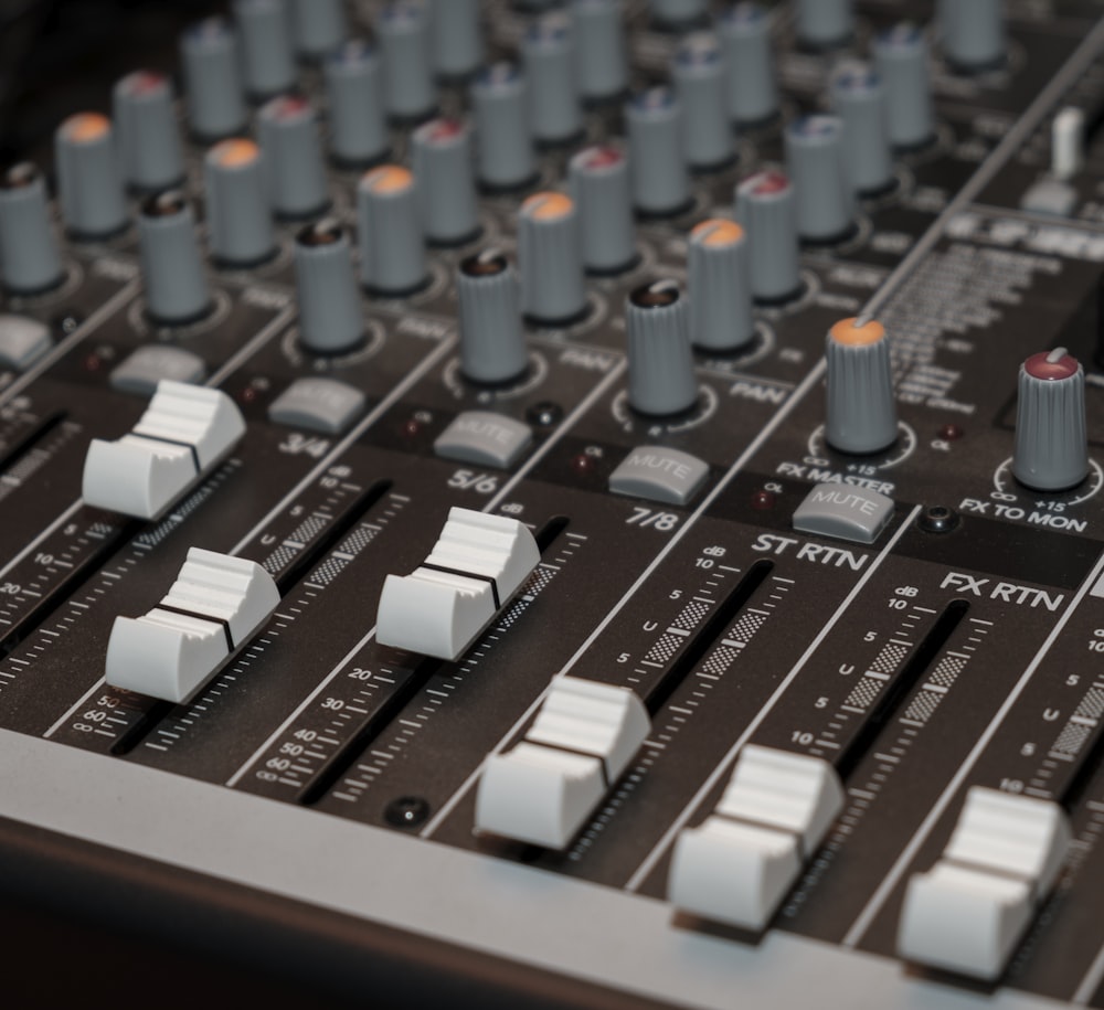 a close up of a mixing board with knobs