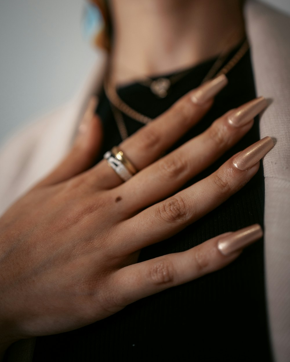 a woman's hands with two rings on her fingers
