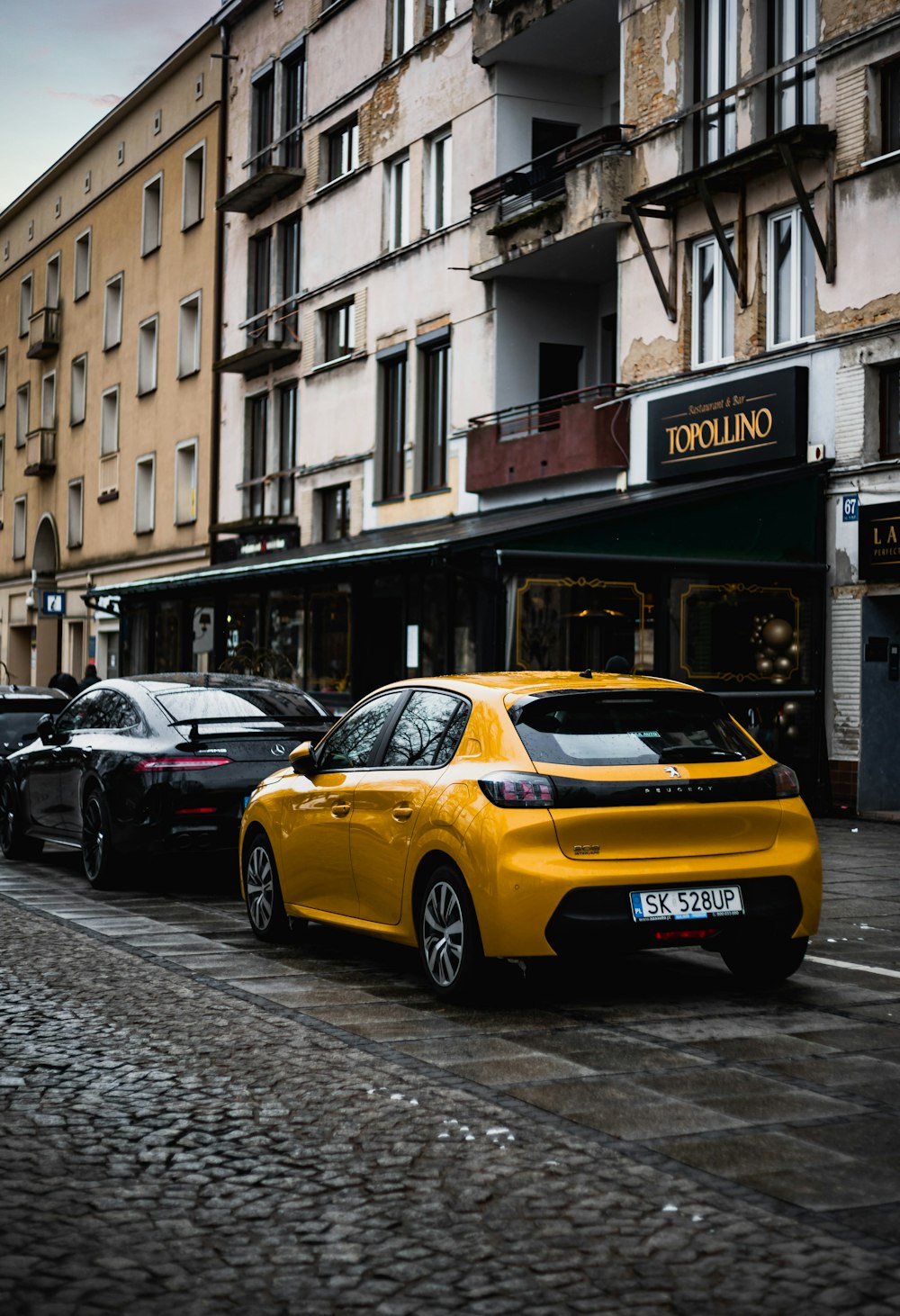 a yellow car parked on the side of a street