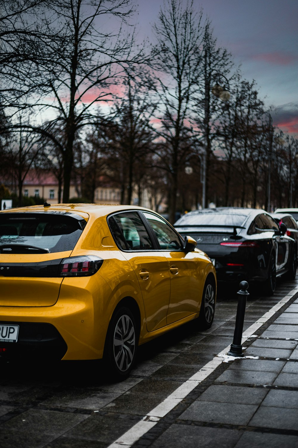 a yellow car parked on the side of the road