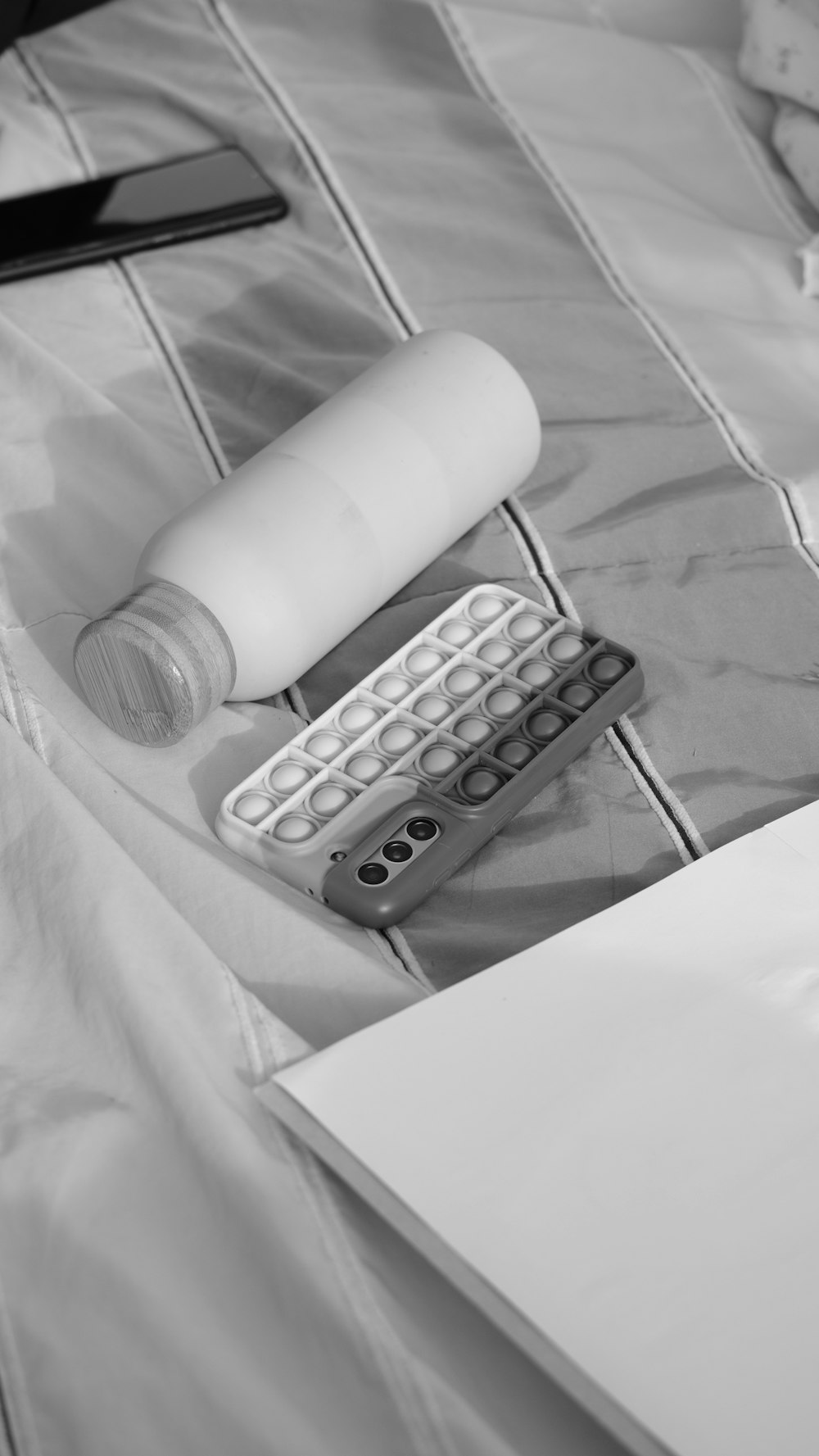 a computer keyboard and a mouse on a bed