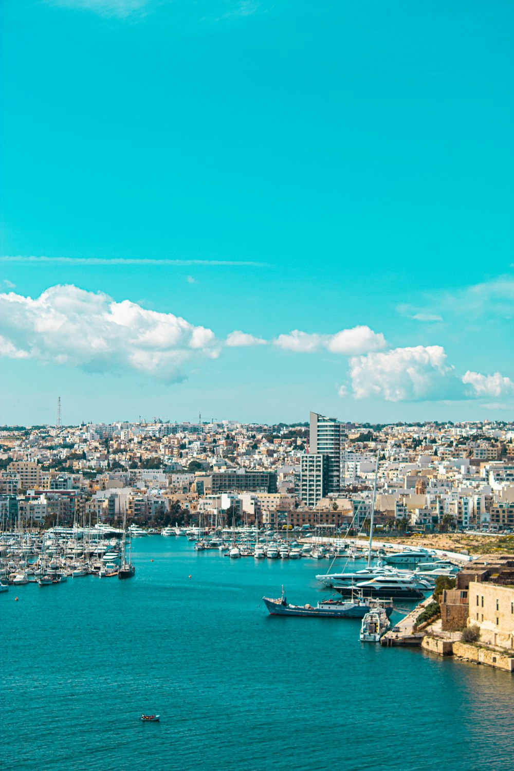 a harbor filled with lots of boats under a blue sky