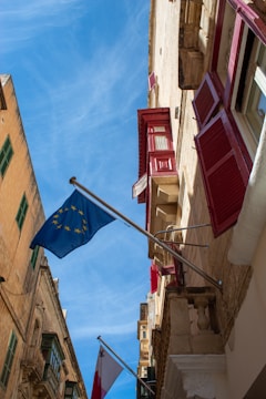 a european flag flying in front of a building
