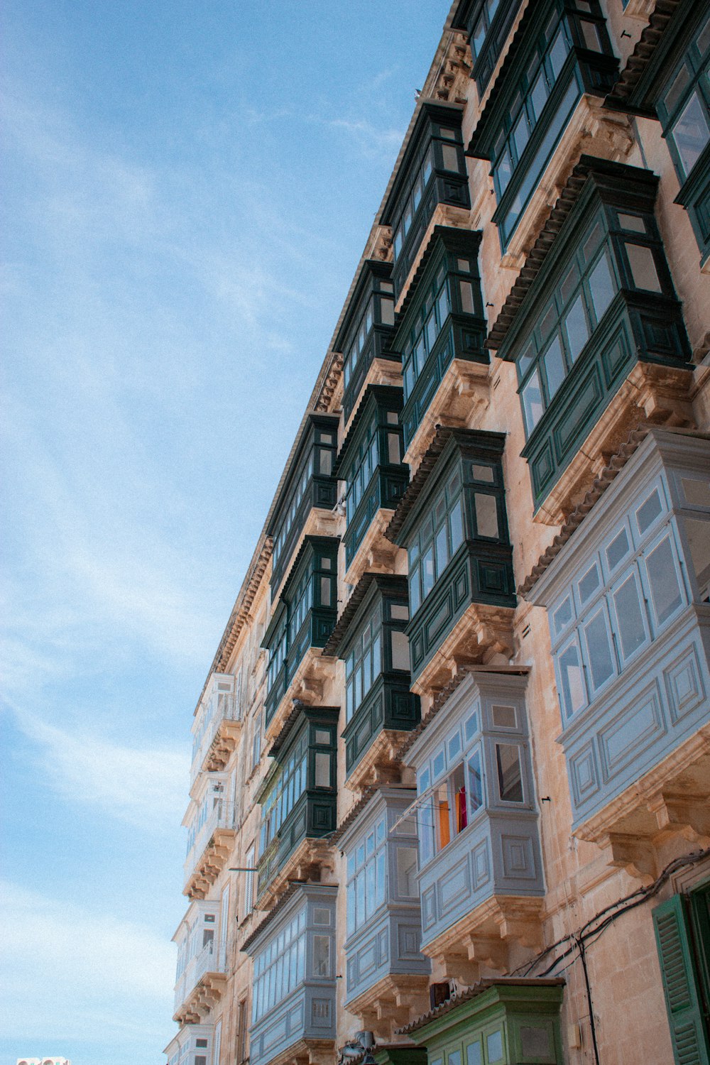 a tall building with lots of windows and balconies