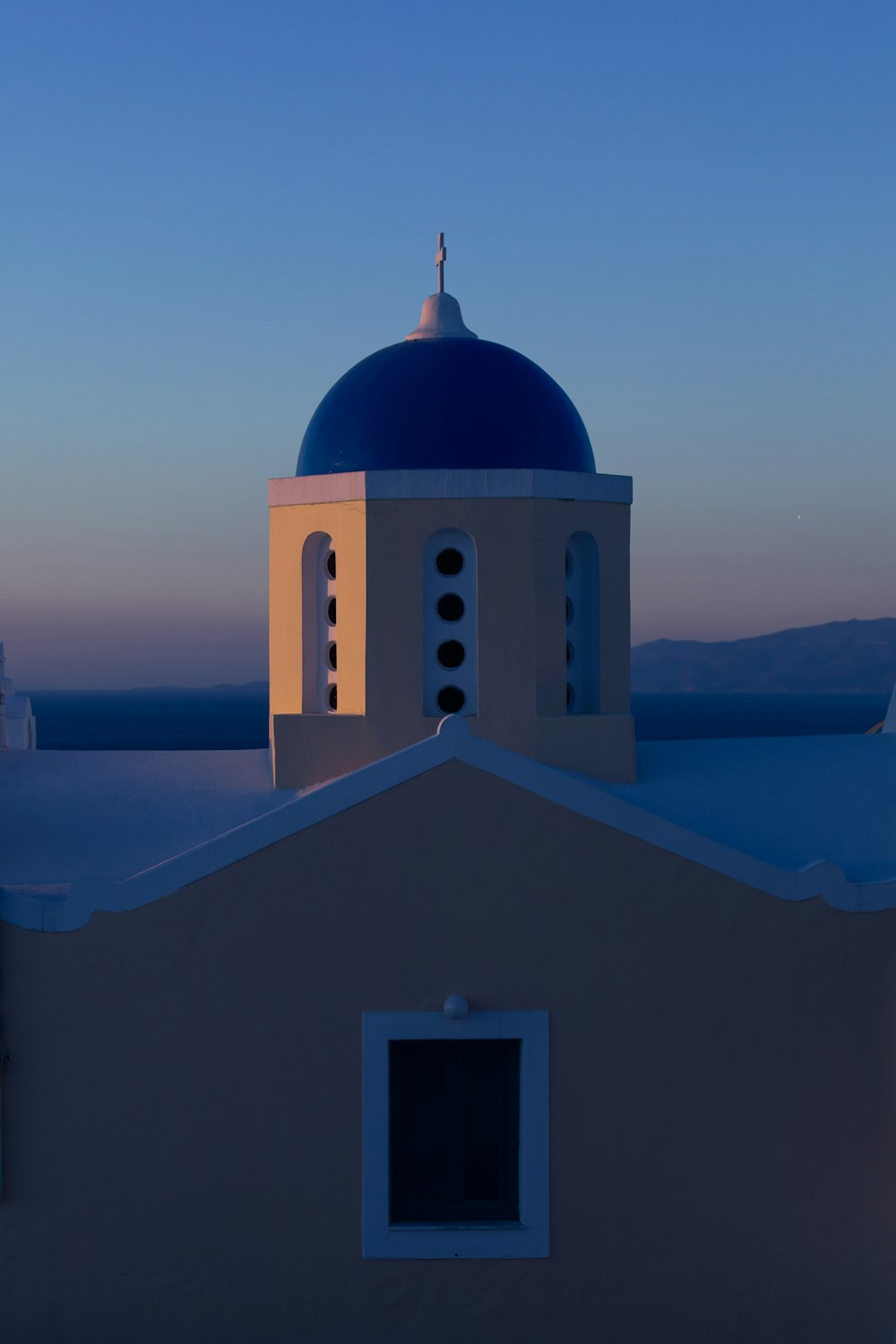 a white building with a blue dome on top of it