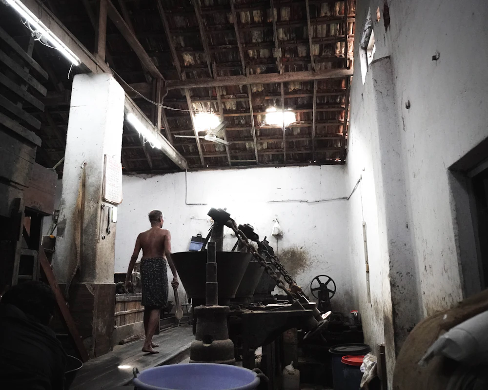 Worker in a small traditional factory with older machinery