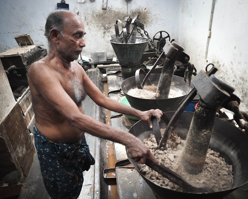 an old man is making food in a kitchen