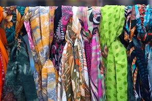 a row of colorful scarves hanging on a clothes line